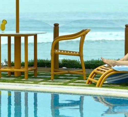 Guests relaxing by the pool and sea Guests relaxing by the pool and sea